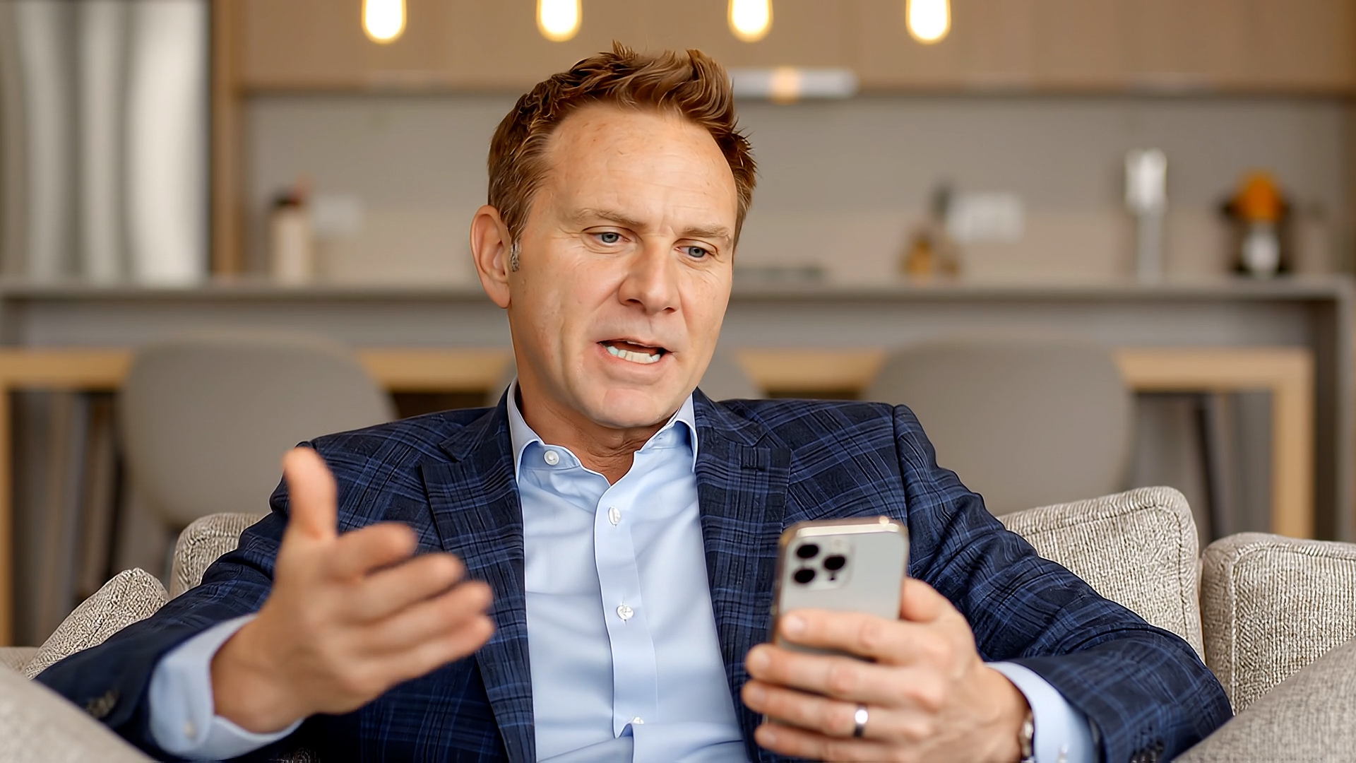 Founder seated in conversation while holding a phone, documenting the build in real time.